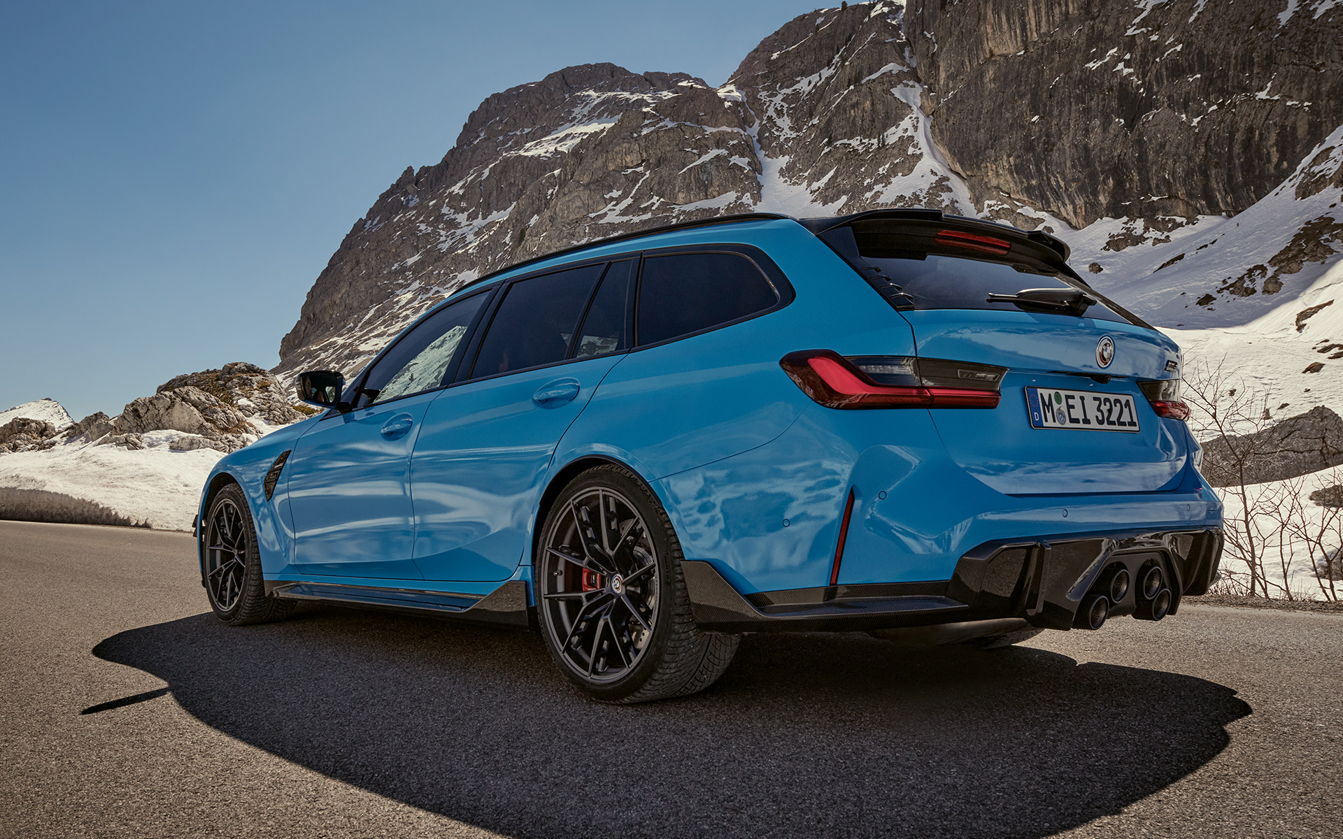 BMW M3 Touring G81 Accesorios M Performance, vista de tres cuartos del lateral, en marcha BMW M3 Touring G81 Accesorios M Performance, vista de tres cuartos del lateral, en marcha delante de un paisaje de montaña