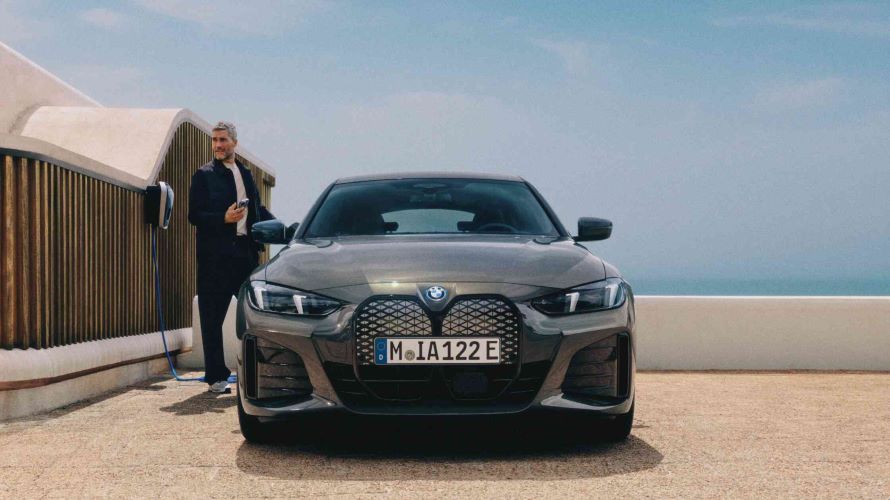 Una persona sostiene una tarjeta BMW Charging en un punto de carga público